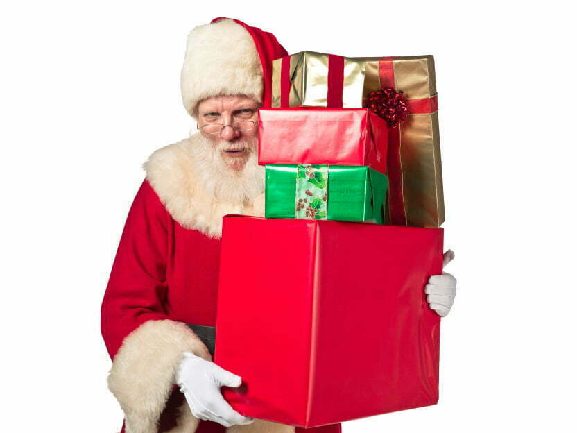 Santa holding a pile of presents