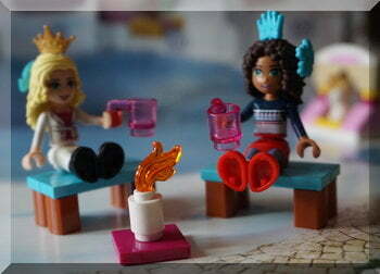 Lego girls sitting on benches with mugs