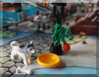 Lego husky with a dirnking bowl under a street lamp