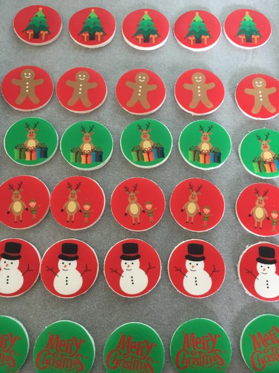 numerous cupcakes topped with a red or green Christmas topper