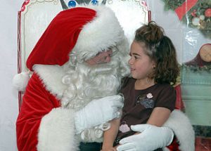 girl sitting in Santa's lap[