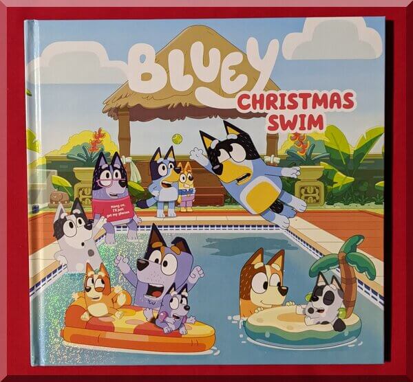 front cover of Bluey - Christmas swim, showing Bluey and the other heelers in and around a backyard pool